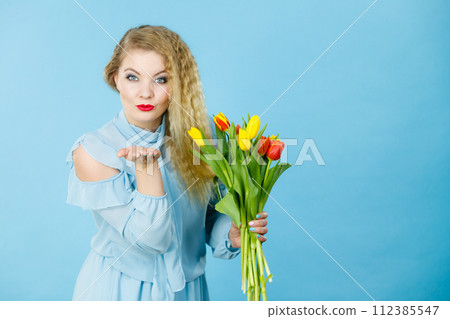 Pretty woman with red yellow tulips bunch 112385547