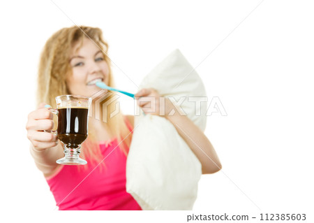 Happy woman holding toothbrush and coffee Happy woman holding toothbrush and coffee 112385603