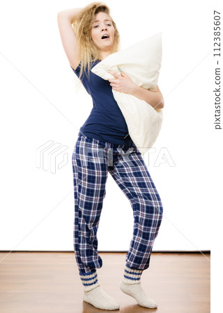 Sleepy woman wearing pajamas Sleepy woman wearing pajamas 112385607
