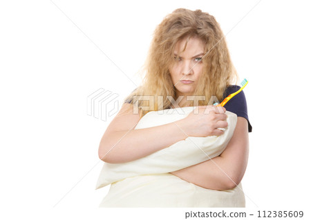 Sleepy woman hugging white pillow 112385609