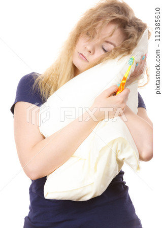Sleepy woman hugging white pillow 112385610