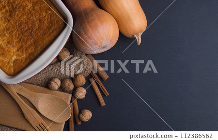 fall baking with pumpkin, food ingredients, spices . Cooking pumpkin pie for Thanksgiving day. fall baking with pumpkin, food ingredients, spices . Cooking pumpkin pie for Thanksgiving day. 112386562