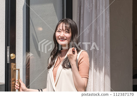 A woman coming out of the beauty salon (hair set, perm, curl) 112387170