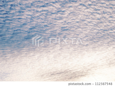 Sunset sky background. Picturesque colorful pink clouds in the sky. Blue sky background. sunset sky Sunset sky background. Picturesque colorful pink clouds in the sky. Blue sky background. sunset sky 112387548