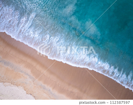 Amazing Top view sea beach landscape background,Summer sea waves crashing on sandy shore seascape background,High angle view ocean nature background 112387597