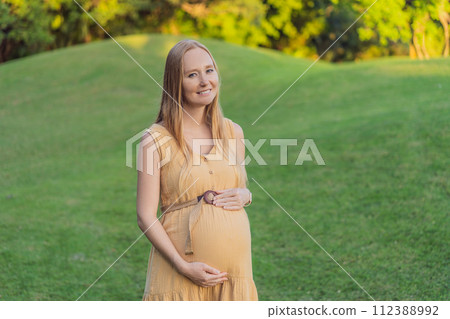pregnant woman finds joy and serenity, relishing a tranquil moment outdoors during her pregnancy journey 112388992