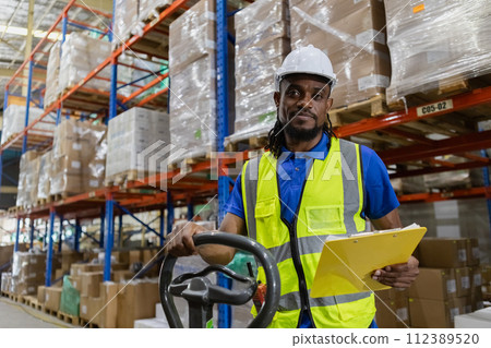 Warehouse industrial stock storage, Man African American worker wear safety uniform push load cart 112389520