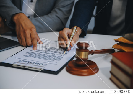 Consultation and conference of Male lawyers and professional businesswoman working and discussion having at law firm in office. Concepts of law, Judge gavel with scales of justice. 112390828