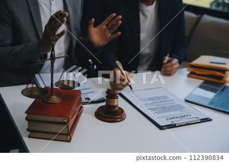 Consultation and conference of Male lawyers and professional businesswoman working and discussion having at law firm in office. Concepts of law, Judge gavel with scales of justice. 112390834