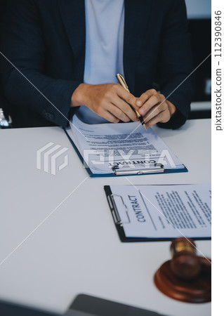 Consultation and conference of Male lawyers and professional businesswoman working and discussion having at law firm in office. Concepts of law, Judge gavel with scales of justice. Consultation and conference of Male lawyers and professional businesswoman working and discussion having at law firm in office. Concepts of law, Judge gavel with scales of justice. 112390846