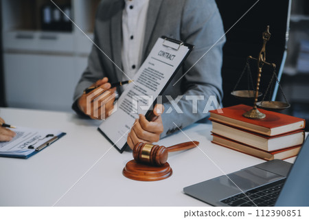 Consultation and conference of Male lawyers and professional businesswoman working and discussion having at law firm in office. Concepts of law, Judge gavel with scales of justice. Consultation and conference of Male lawyers and professional businesswoman working and discussion having at law firm in office. Concepts of law, Judge gavel with scales of justice. 112390851