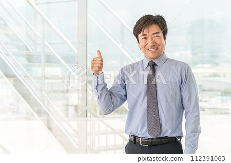 Middle-aged Asian male businessman in an office building (Good/OK/Nice/Like) Middle-aged Asian male businessman in an office building (Good/OK/Nice/Like) 112391063