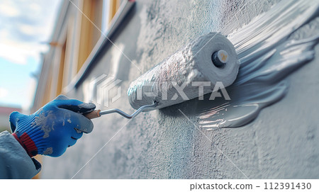 Contractor painting exterior walls 112391430