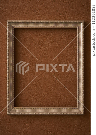 Antique picture frame hung on brown wallpaper Antique picture frame hung on brown wallpaper 112391852