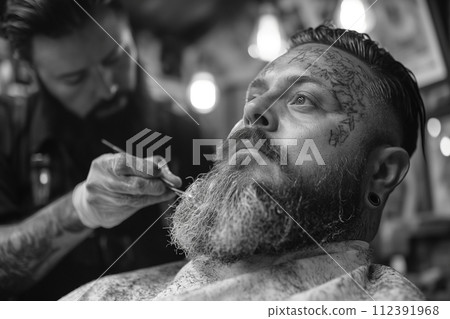 Barber cutting beard of customer in shop. 112391968