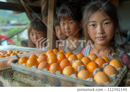 The girls collected chicken eggs in cardboard containers 112392140