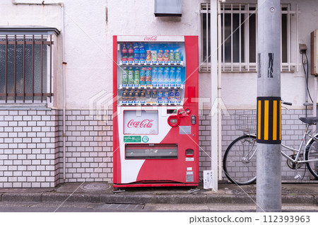 Tokyo, Japan -October  1  , 2023 :  Vending machines in Tokyo, Japan. Coca-Cola vending machine on a residential street 112393963