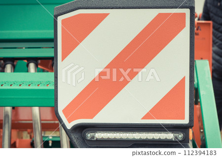 Warning sign in industrial or agricultural machine informing about danger Warning sign in industrial or agricultural machine informing about danger 112394183