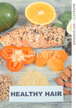 Various nutritious products or ingredients containing vitamins and minerals for healthy hair 112394206