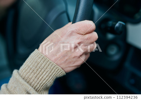 Senior woman driving a car 112394236