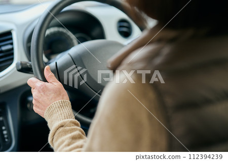 Senior woman driving a car Senior woman driving a car 112394239