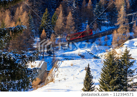 Red ski funicular in the Swiss Alps in winter resort Davos, Switzerland Red ski funicular in the Swiss Alps in winter resort Davos, Switzerland 112394571