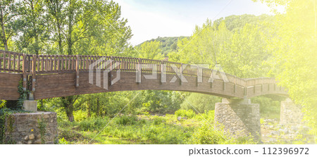 Wooden bridge in forest of Spain on soft sunlight 112396972