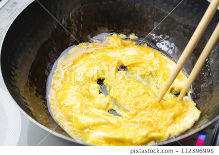 fry eggs in a cast iron pot 112396998