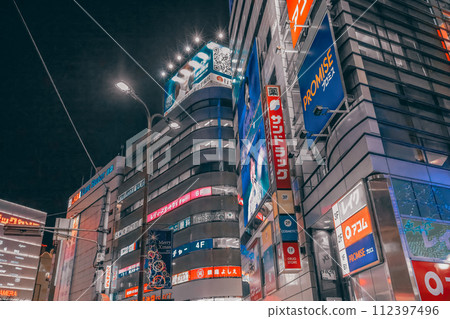 Nov 28 2023 Busy city street at night with skyscrapers and a crowd. Nov 28 2023 Busy city street at night with skyscrapers and a crowd. 112397496