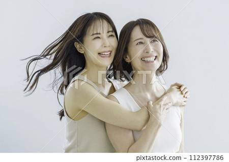 Mother and daughter portrait of daughter and mom in their 30s 112397786