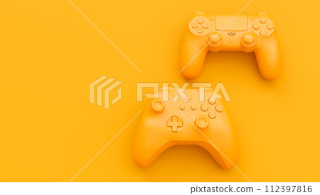 Video game joysticks or gamepads in plain monochrome yellow color background 112397816