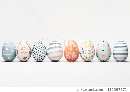 A row of colorful pastel Easter eggs, each uniquely painted with different texture on a white background 112397871