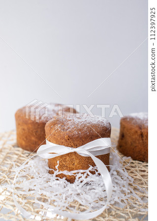 Easter pastries, sponge cake with a white bow is on a napkin. Quail eggs. Place for text Easter pastries, sponge cake with a white bow is on a napkin. Quail eggs. Place for text 112397925