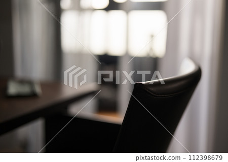 Blurred background of dining room with leather chair closeup Blurred background of dining room with leather chair closeup 112398679