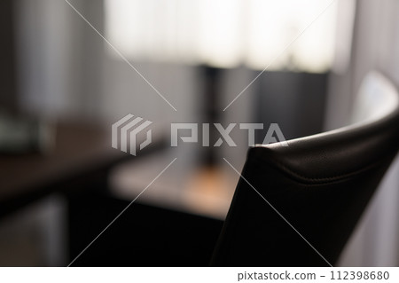 Blurred background of dining room with leather chair closeup Blurred background of dining room with leather chair closeup 112398680