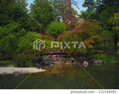 Japanese park in Vienna on a summer day. Zetagaya Park is small, quiet Japanese garden with cherry trees and fish pond, open to public from April to October. Japanese park in Vienna on a summer day. Zetagaya Park is small, quiet Japanese garden with cherry trees and fish pond, open to public from April to October. 112399084