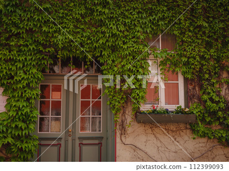 spring trip to Europe. Travel and German sightseeing locations. scenic view to facade of old historic houses somewhere in Erfurt city, details of ancient medieval houses, windows and doors 112399093