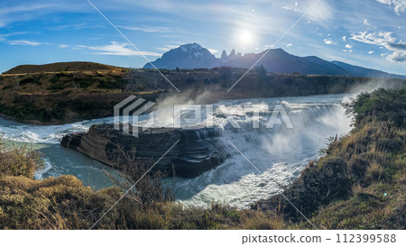 Majestic Waterfall with Mountain Backdrop at Sunrise Majestic Waterfall with Mountain Backdrop at Sunrise 112399588