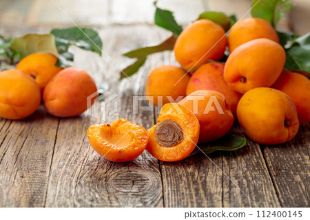 Fresh apricots on a old wooden table. 112400145