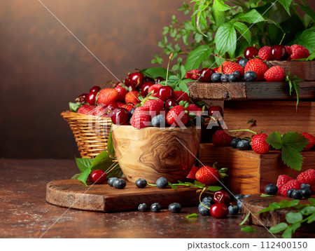 Assorted fresh berries with leaves. Assorted fresh berries with leaves. 112400150
