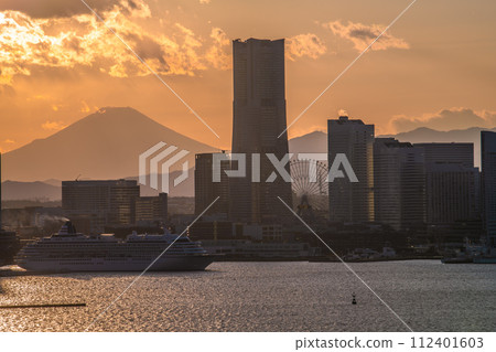 Japan's Yokohama cityscape View of Minato Mirai, Mt. Fuji, and Asuka II departing from Osanbashi. Back left is towards Sakuragicho Station 112401603