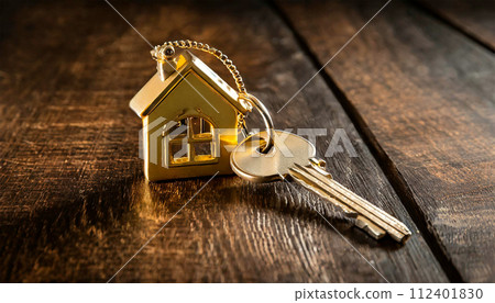 House Key with Golden House Shaped Keychain on Wooden Background - Generative Ai House Key with Golden House Shaped Keychain on Wooden Background - Generative Ai 112401830