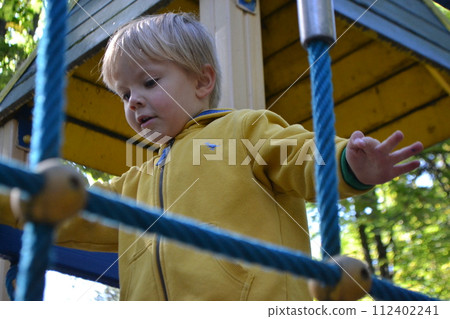 Kids having fun in ferris wheel with chains, carousel ski flyer in amusement park in Targoviste, Romania, 2020. High quality photo Kids having fun in ferris wheel with chains, carousel ski flyer in amusement park in Targoviste, Romania, 2020. High quality photo 112402241