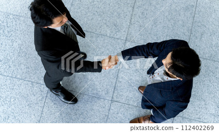 two male businessmen shaking hands two male businessmen shaking hands 112402269