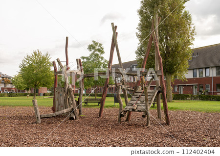 Rustic Wooden Playground in Suburban Park Rustic Wooden Playground in Suburban Park 112402404