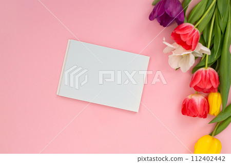 Blank white card with colorful tulips on a pink background. 112402442