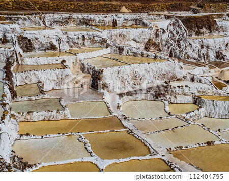 Amazing colors and geometries of Maras salt ponds in the sacred valley of Incas, Cusco region, Peru 112404795
