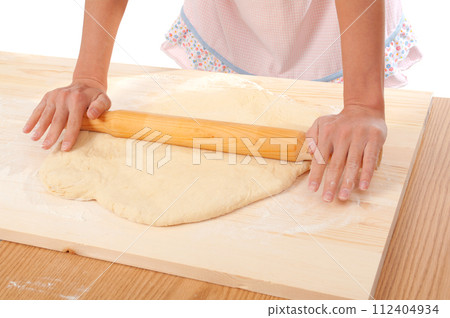 mix dough on the wooden board . mix dough on the wooden board . 112404934
