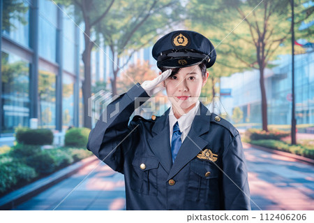 Female police officer salutes Female police officer salutes 112406206