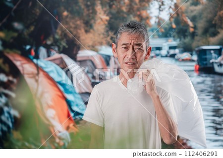 homeless man picking up trash homeless man picking up trash 112406291